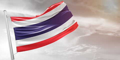 Thailand national flag cloth fabric waving on beautiful grey Background.