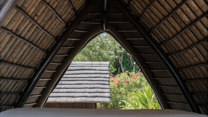 Obraz premium A-Frame Cottage Roof Surrounded by Lush Green Trees in Serene Setting