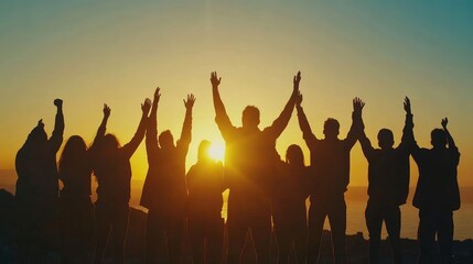 Fototapeta premium Silhouettes of People with Raised Fists at Sunset Representing Freedom and Human Rights