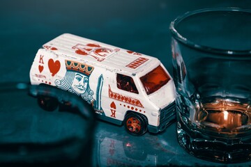 Toy car hit a glass of whisky, truck on the table