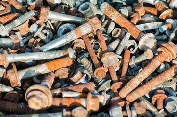 The photo shows old rusty bolts and nuts close-up