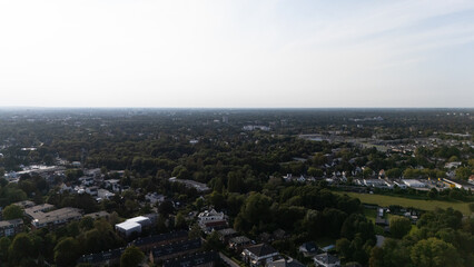Fototapeta premium Expansive Aerial View of Suburban Neighborhood and Lush Forest