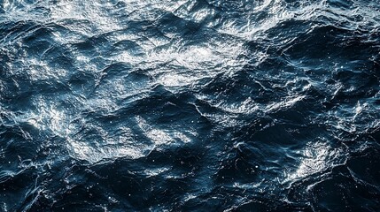 Fototapeta premium A stunning close-up of ocean waves, showcasing the deep blue hues and the dynamic movement of water reflecting sunlight. Ideal for nature themes.