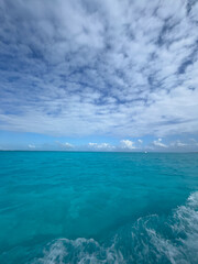 Peaceful Ocean View Under a Cloudy Sky with Blue Waters