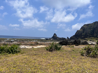 Rocky Tropical Coastline Under Bright Blue Sky