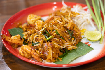 Delicious pad thai dish thai restaurant food photography cozy setting close-up view culinary art