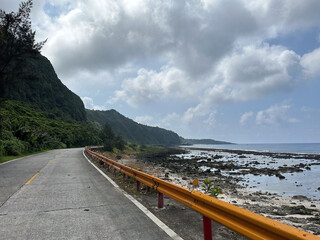 Scenic Coastal Road by the Rocky Shoreline on a Cloudy Day
