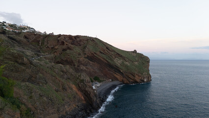Scenic View of Rocky Coastline and Tranquil Blue Sea at Dusk