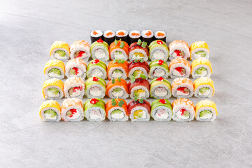 Japanese sushi rolls, sushi sets on a gray background for restaurant menu and food delivery