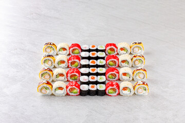 Japanese sushi rolls, sushi sets on a gray background for restaurant menu and food delivery