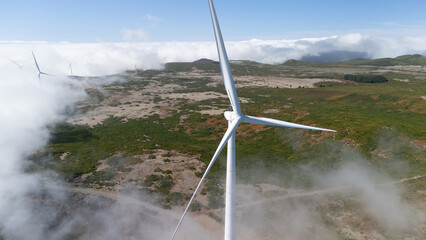 Wind Turbine Among Clouds in Scenic Landscape