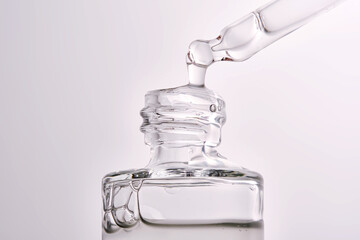 Close-up of a cosmetic bottle with a pipette showing the texture of the serum.