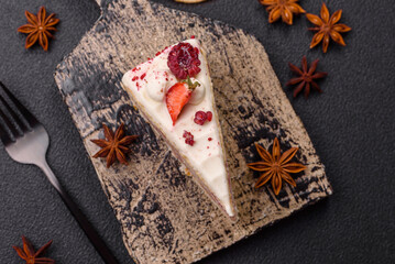 Piece of sweet layer cake with white cream, raspberries and strawberries