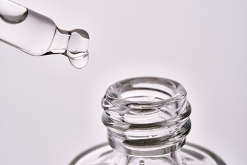 Close-up of a cosmetic bottle with a pipette showing the texture of the serum.