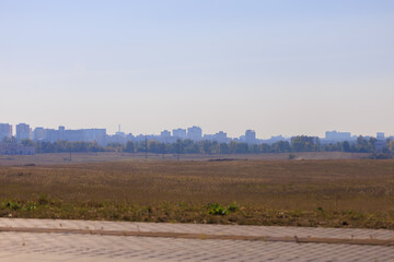 Road shoulder on a sunny autumn day. Views of the landscape from the car window.