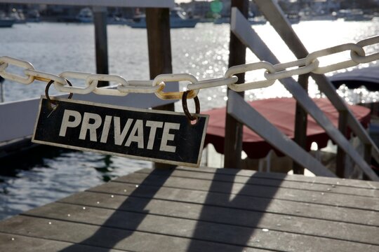 private property sign hangs from the boat dock