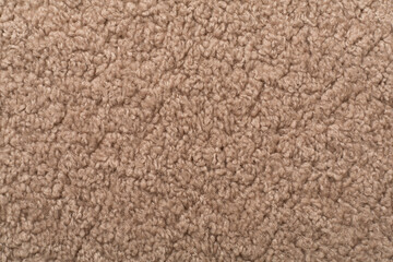 Brown cuddle teddy bear fabric as background, top view © Liami