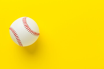 Baseball ball on color background, top view