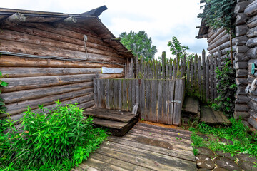The interior of an old village stable, Walls with wooden beams. A cattle pen and a wooden floor