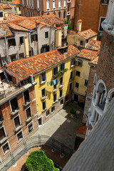 an iconic overview over a narrow alley from above in Venice, Italy. With stretched clotheslines...
