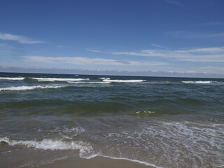 Serene sea landscape with waves and blue sky on the horizon