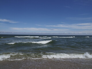 Seascape with Waves on Sandy Beach under Blue Sky