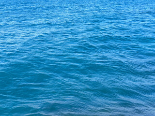 Blue water calm sea ripples surface background.