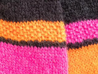 Brightly coloured pink, black and orange mohair and alpaca hand knitted sweater, knitted in stocking stitch, moss stitch and rib stitch. 
