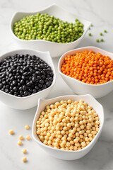 Fototapeta premium Variety of Colorful Legumes and Pulses in White Bowls on Marble Surface