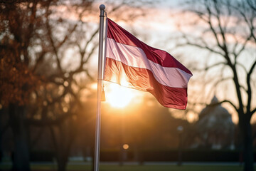 Latvian flag waving at sunset outside a historic building in Riga, Latvia