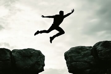 Silhouette a man jumping over cliffs, symbolizing determination and a positive mindset