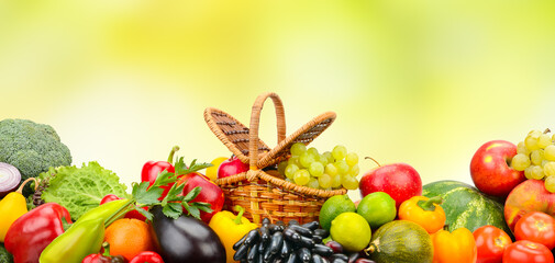 Collection berries, fruits and vegetables on green background.
