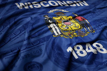 waving colorful wisconsin state flag on the dollar money background. finance concept.