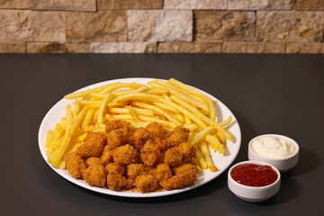 crispy chicken and French fries with ketchup, mayonnaise