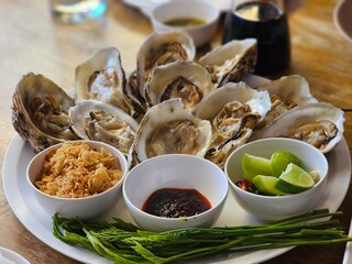 Oysters on a plate seafood restaurant culinary art indoor dining close-up freshness and flavor