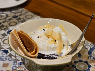 Tasting delight dessert bowl cozy café food photography relaxed atmosphere close-up view culinary indulgence
