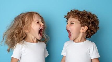 Two young children with curly hair engage in a lively shouting match indoors against a blue background, displaying intense emotions and childhood vitality.