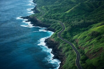 A road runs along the shoreline of a body of water. The road is surrounded by lush green hills and trees. The water is calm and blue, with waves breaking on the shore. The scene is peaceful and serene