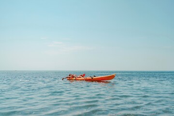 Obraz premium Kayak sea woman. Happy attractive woman with long hair in red swimsuit, swimming on kayak. Summer holiday vacation and travel concept.