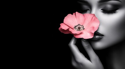 black and white woman holding a beautiful pink flower, isolated black background