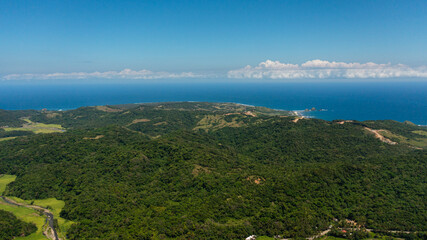 Aerial view of Mountains and hills with tropical vegetation and blue sea. Tropical landscape. Philippines.