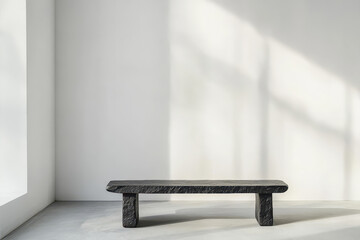 A Sleek Black Lava Stone Bench Elegantly Situated Against a Minimalist White Wall in an Inviting, Serene Space