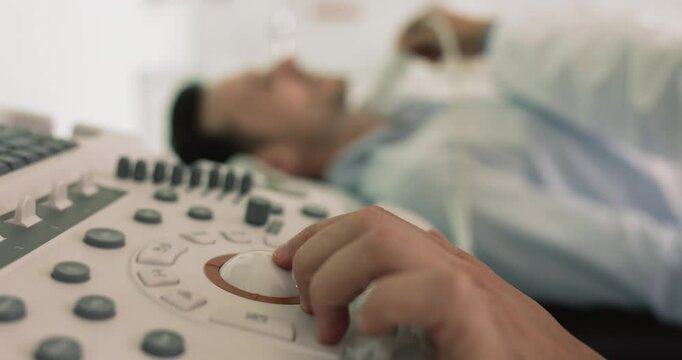 Close up view mature 40s male patient visited clinic for regular check-up of endocrine system, for maintaining overall health, detect potential issues. Medicare, modern equipment, sonographer workflow