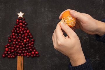 male hands peeling a tangerine