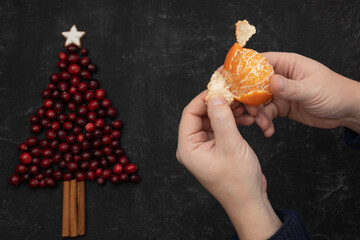 male hands peeling a tangerine