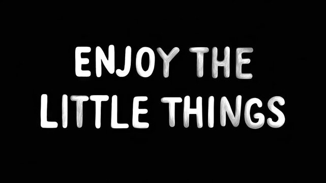 Positive motivational phrase &ldquo;Enjoy the little things&rdquo; white frase on black background