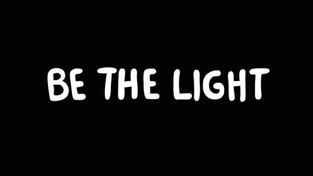 Positive motivational phrase &ldquo;Be the light&rdquo; white frase on black background