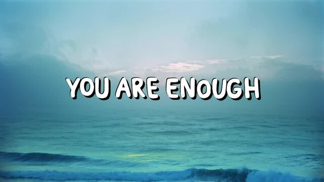 Positive motivational phrase &ldquo;You are enough&rdquo; on a dreamy background written in cheerful letters