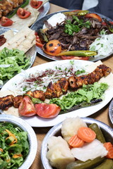 The most common variety of kebab is marinated lamb or beef cooked on a skewer. Vegetables are sometimes cooked along with them, wherein typical vegetables include eggplant, tomato, bell pepper, onions