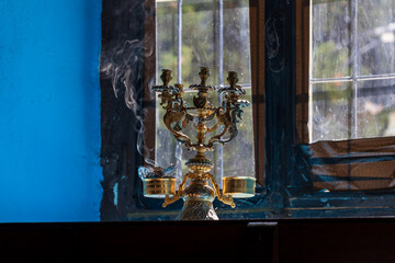 Lit candles in the Kalopetra Monastery